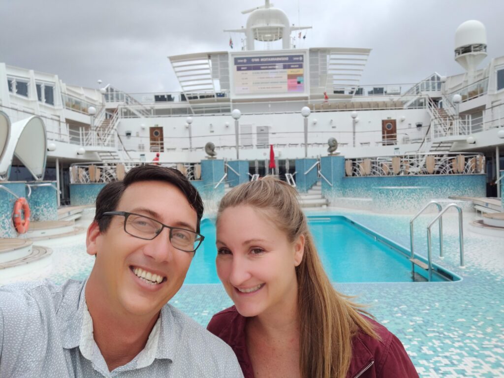 John & Heather, publishers of RoamingAroundtheWorld, take a selfie atop a cruise ship