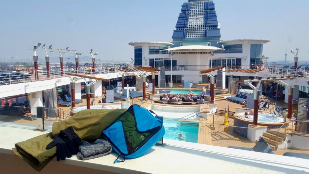 Packing cubes on deck of cruise ship, packing winter clothes while cruising to warmer tropical climate