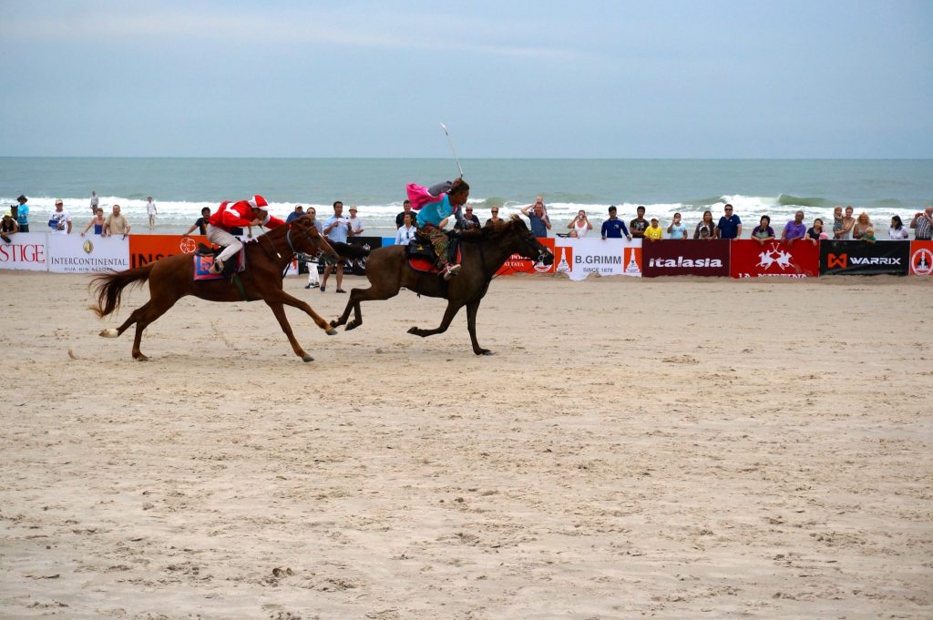 Two horses racing on the beach