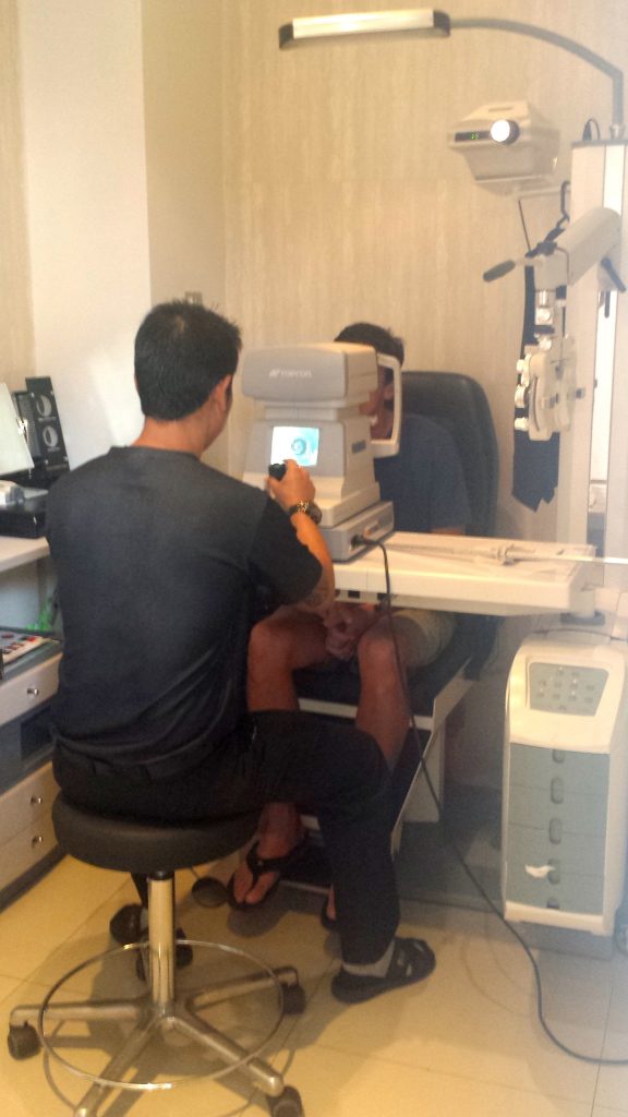 John getting an eye exam in Bangkok