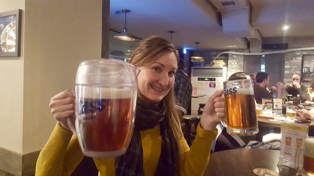 Heather with pitcher of Cass beer in South Korea