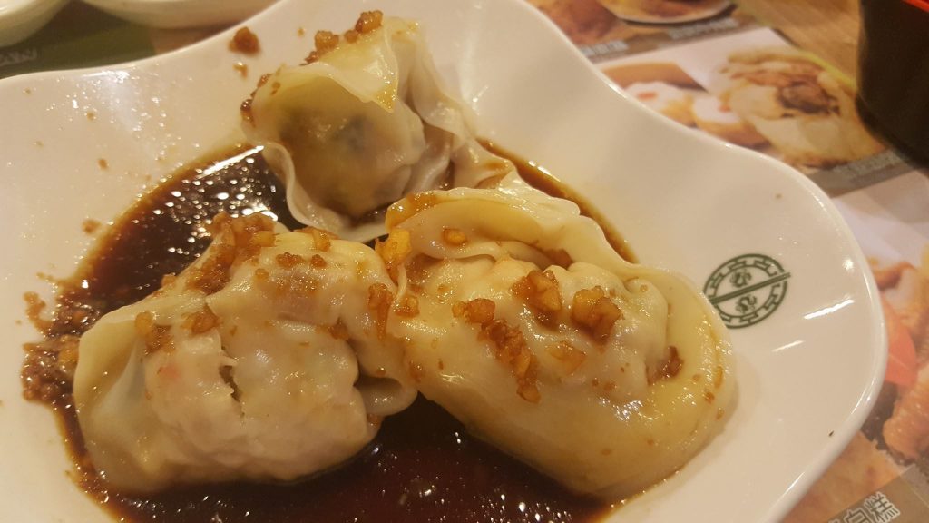 pan-fried pork & veggie dumplings in a chili sauce at Tim Ho Wan