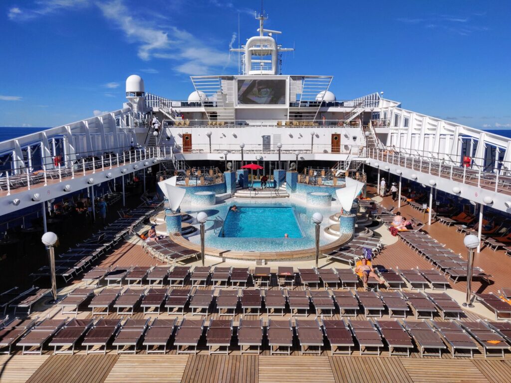 an empty pool deck during a repositioning cruise, where a benefit is that it can be easy to avoid crowds